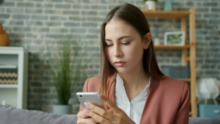 A woman checking her phone with no new messages on the screen