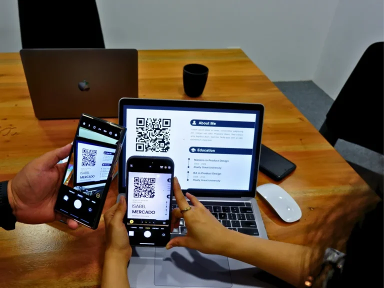 Two people looking at their phones across a table