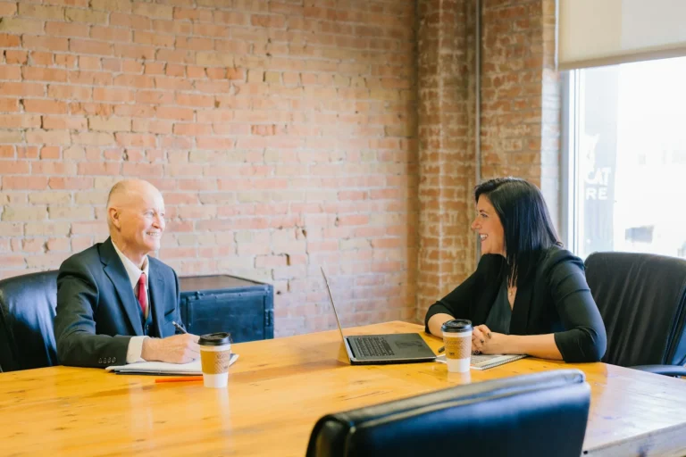 Business owner meeting an agency consultant across a conference table