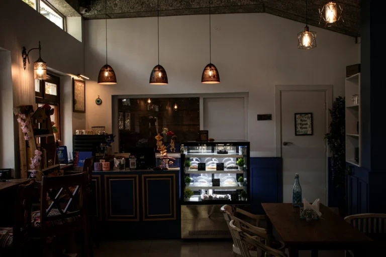 Warmly lit cafe interior with pendant lights and a pastry counter