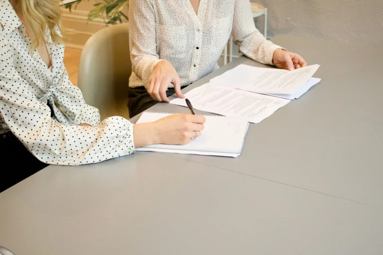 Business owner reading and signing an agency contract at a desk
