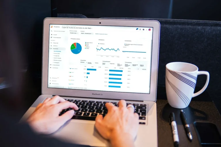 Person working on a laptop showing a website analytics dashboard