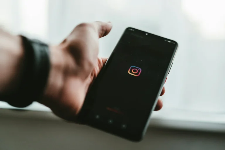 Hand holding a smartphone opening the Instagram app