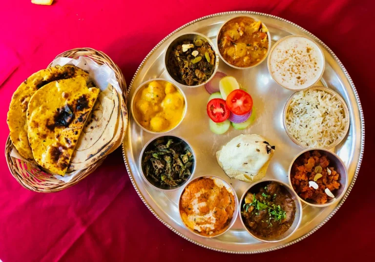 Indian thali with rotis, rice and small bowls of curries on a steel plate