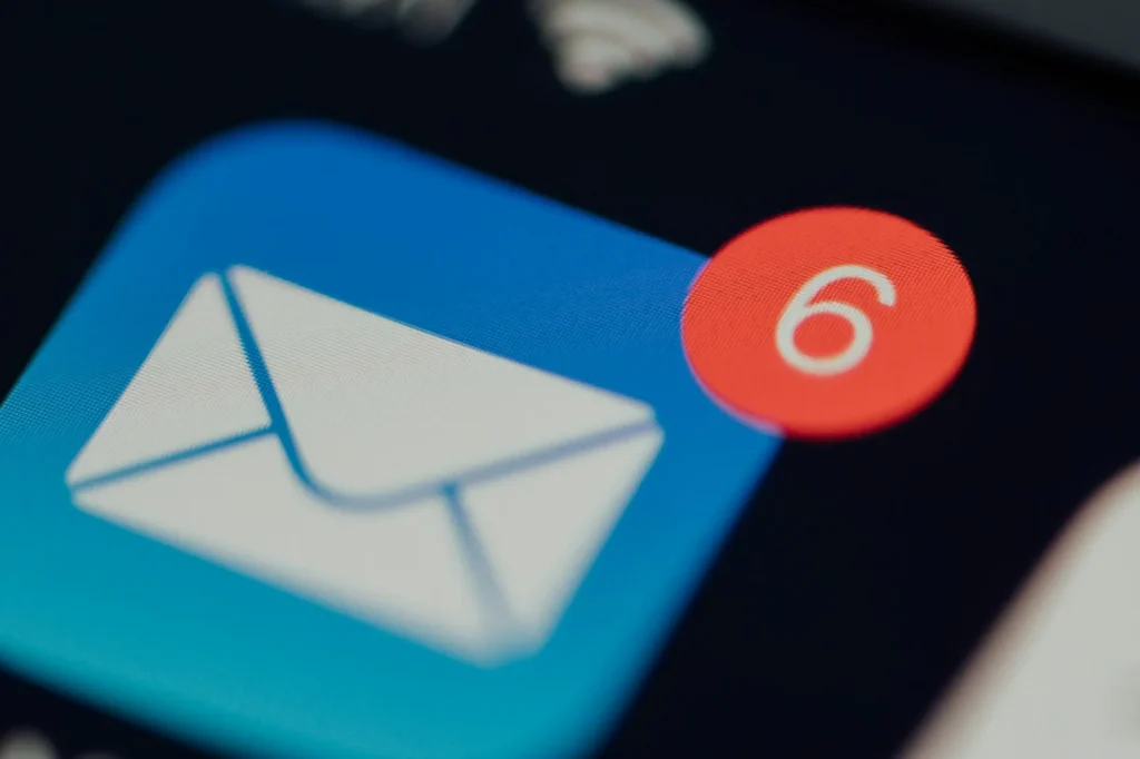 What is email marketing: phone showing a mail app icon with six new email notifications