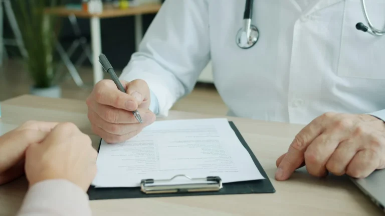 Doctor in a white coat signing a document on a clipboard, approving hospital advertising claims