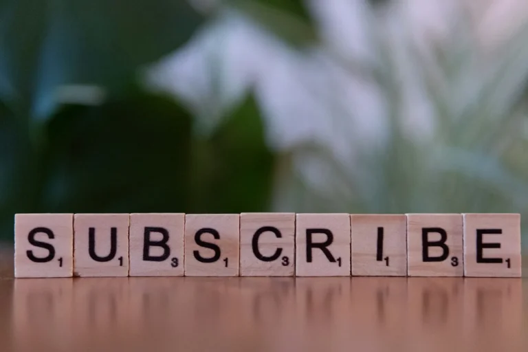 Subscribe letter tiles on a table, a signup prompt for an email list