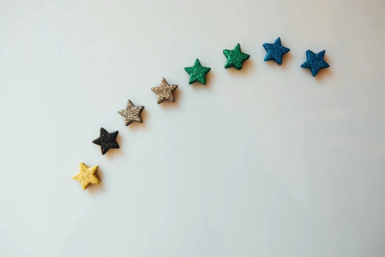 Row of five rating stars on a white surface