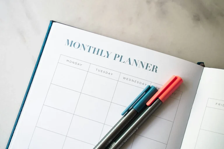 Monthly planner with pens, for planning a simple email schedule