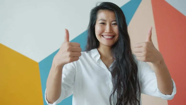 Woman giving two thumbs up after a good customer experience