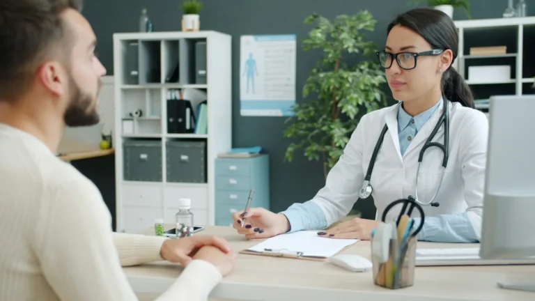 Doctor consulting a patient at a clinic desk, a local business that runs on enquiries