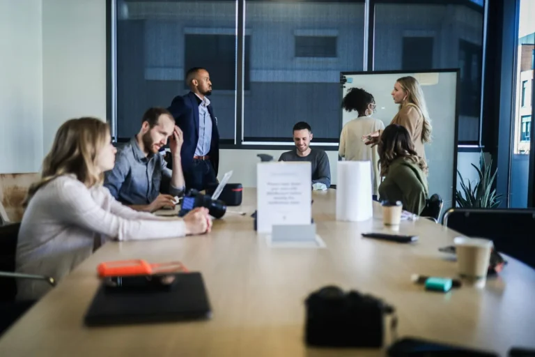A team around a meeting table reviewing a project proposal